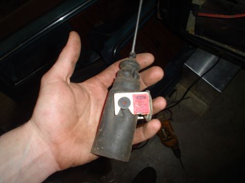 1984 Ford Bronco - A hand holds a car part with a Ford label, suggesting it is from a Ford vehicle.