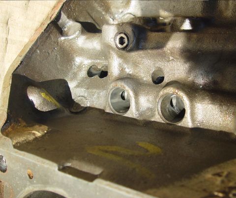 1969 Ford Fairlane - Close-up view of the internal structure of an engine block, showing machined cylinders and bolt holes.