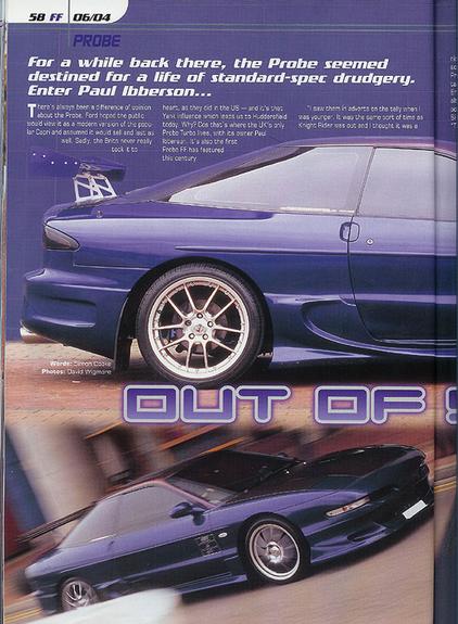1993 Ford Probe - A modified blue sports coupe is shown from a three-quarter front view, a prominent rear spoiler and aftermarket wheels.
