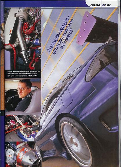 1993 Ford Probe - Close-up of a modified purple sports car's rear, highlighting its spoiler and wheel.