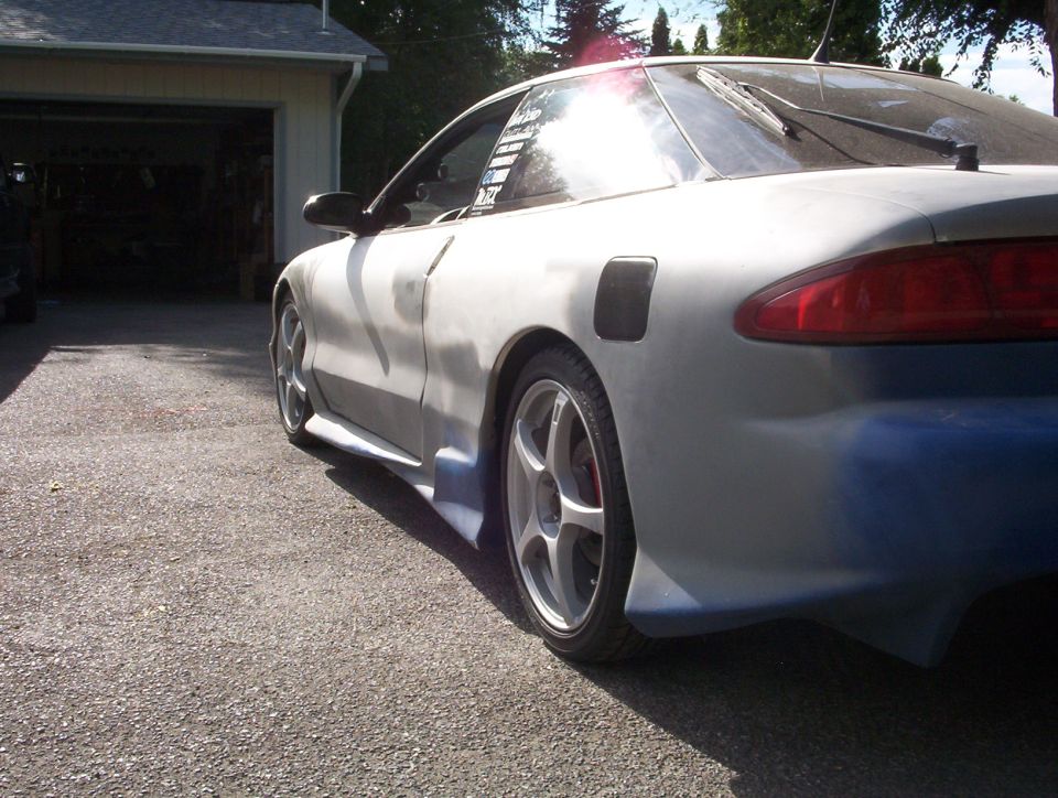Ford Probe coupe in gray primer mid-bodywork, rear three-quarter view