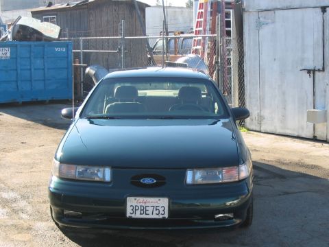 1995 Ford Taurus - This 1995 Ford Taurus is seen from the front, parked in an industrial area.