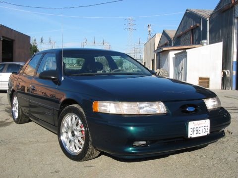1995 Ford Taurus - This 1995 Ford Taurus sedan is seen from a 3/4 front angle, parked outdoors.