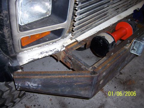 1985 Ford Bronco - A custom metal bumper is attached to the front of a white 1980s Ford Bronco.