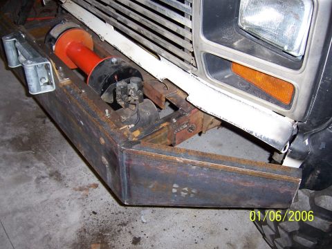 1985 Ford Bronco - Custom bumper with winch installed, showing part of the vehicle's front end.