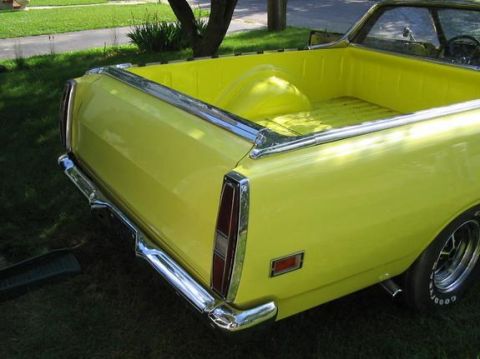 1970 Ford Ranchero - Rear view of a yellow 1970 Ford Ranchero, showing its distinctive pickup bed and chrome trim.