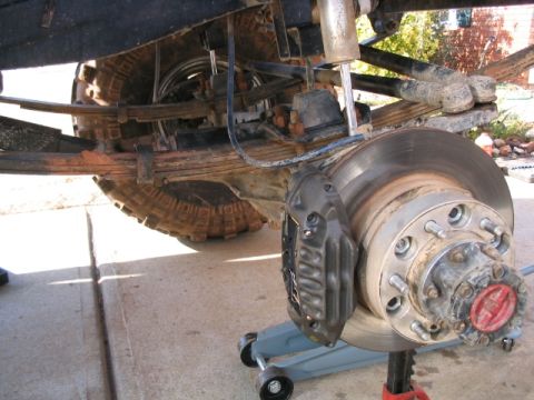 1986 Ford F-150 - Rear axle and suspension components of a truck, including leaf springs and brakes.