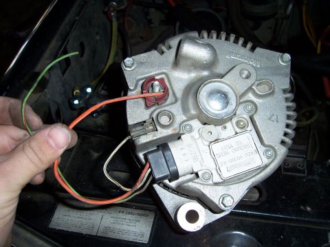 1983 Ford Bronco - Close-up of an alternator with wires, part number F4ZU-40310-AC visible.