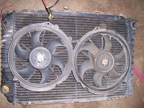 1983 Ford Bronco - Radiator assembly with two electric fans, likely for a vehicle cooling system. Text overlay indicates the source as SUPERMOTORS.