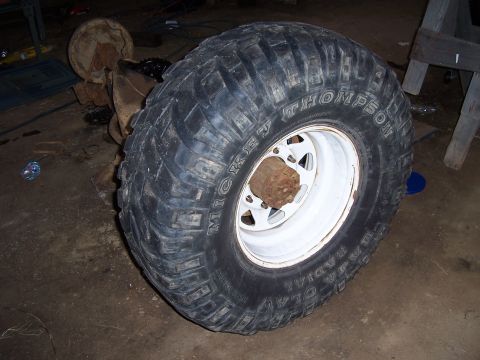 1983 Ford Bronco - A close-up of a large off-road tire and wheel assembly, likely for a truck or SUV.
