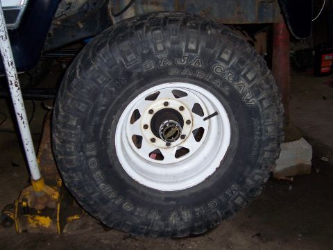 1983 Ford Bronco - A close-up shows the tread and sidewall details of an off-road tire mounted on a white rim.