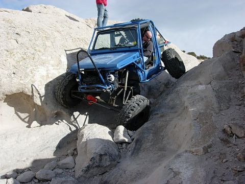 1987 Ford Bronco - Off-road buggy tackles a challenging rocky terrain, demonstrating its climbing capability.