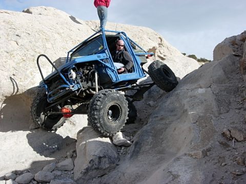 1987 Ford Bronco - This heavily modified off-road vehicle navigates a challenging rocky terrain.