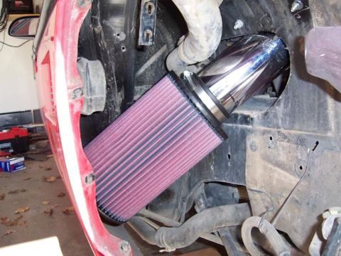 1986 Pontiac Fiero - Close-up of a custom engine air intake system installed in a vehicle's engine bay.