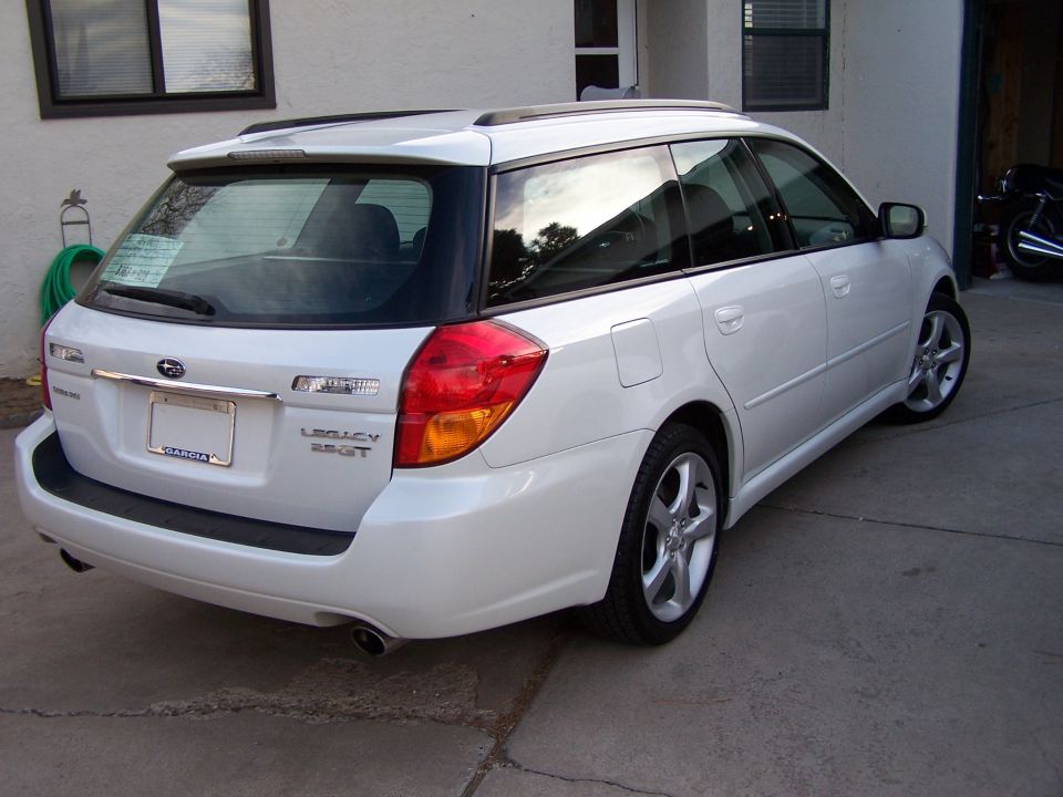 White Subaru Legacy 2.5GT wagon, rear three-quarter view in driveway