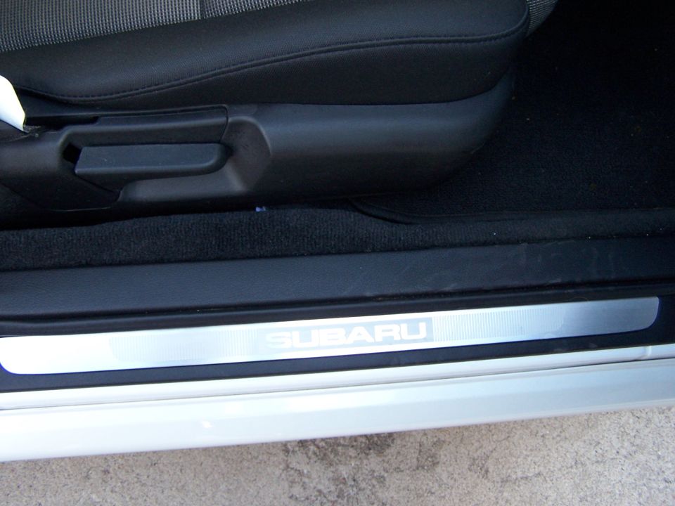 Subaru door sill plate with SUBARU logo and black interior trim