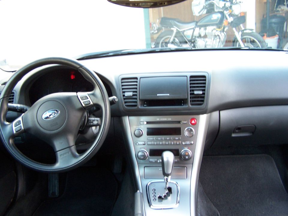 Subaru Legacy black interior dashboard, steering wheel, center console and automatic shifter