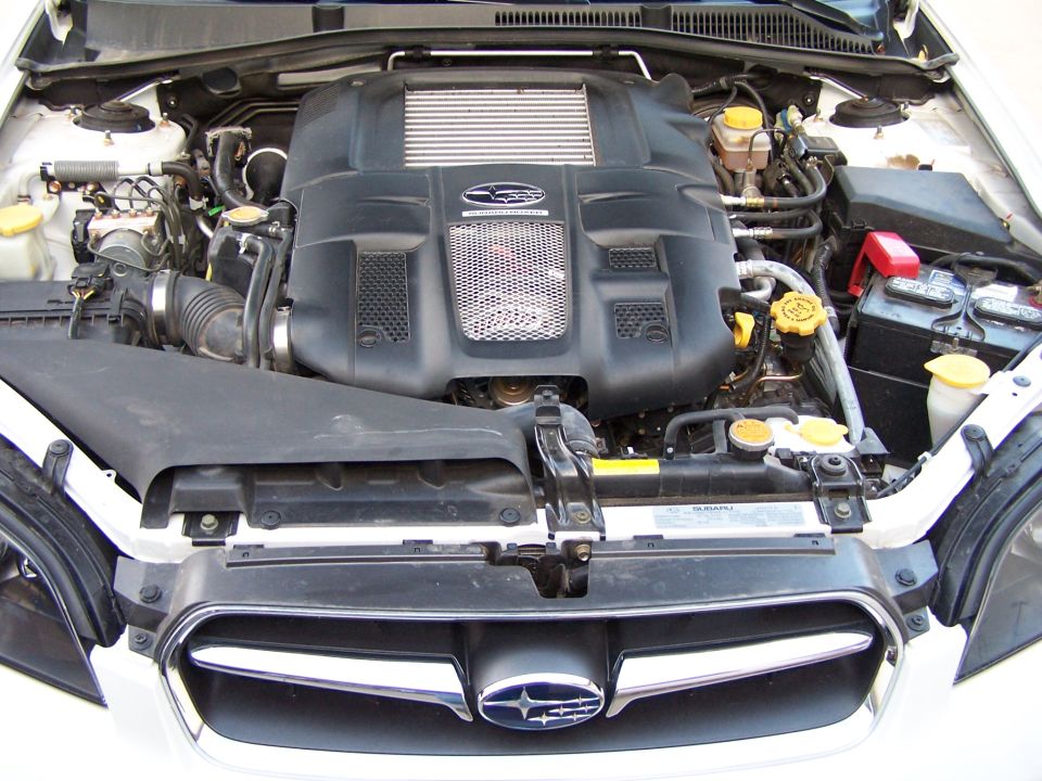 Subaru turbocharged boxer engine bay with black engine cover and top-mount intercooler