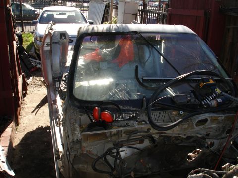 1992 Ford Taurus - Interior view of a deconstructed vehicle, showing exposed wiring and orange safety cones.