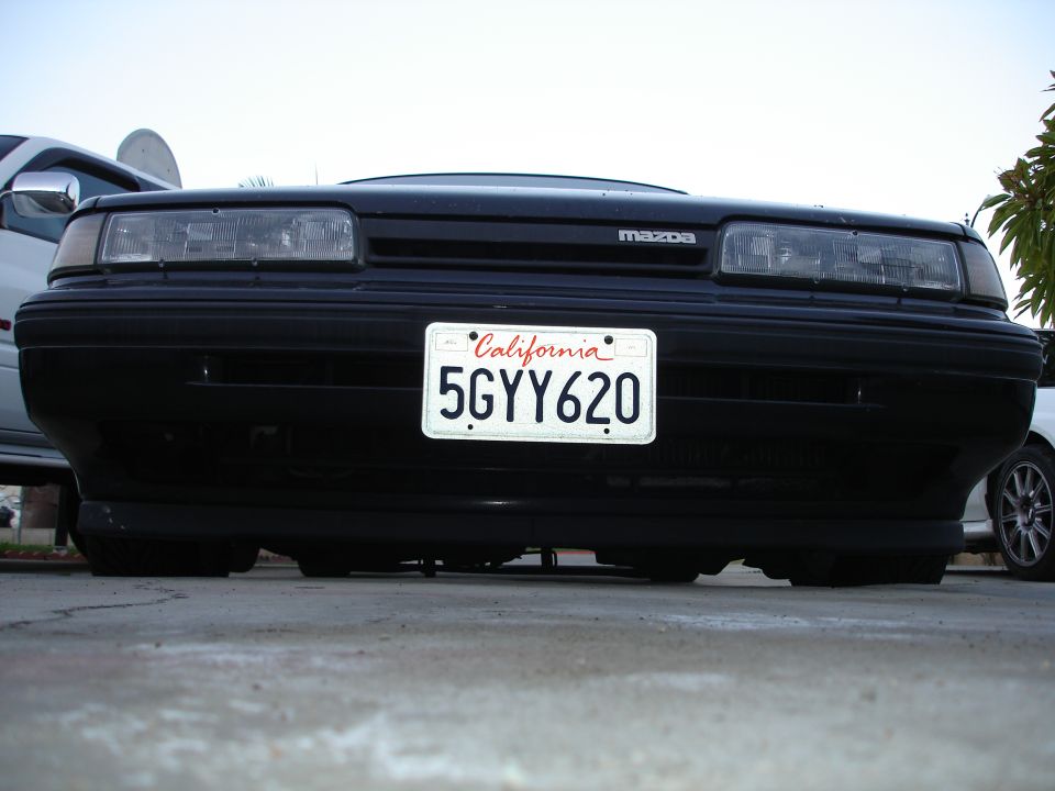 Front view of a black Mazda with a California license plate