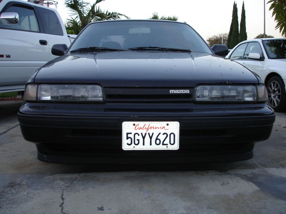 Black 1989 Mazda MX-6 with California license plate 5GYY620, front view
