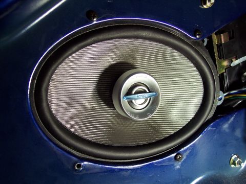 1995 Ford Probe - Close-up of a car's interior door panel an aftermarket speaker.
