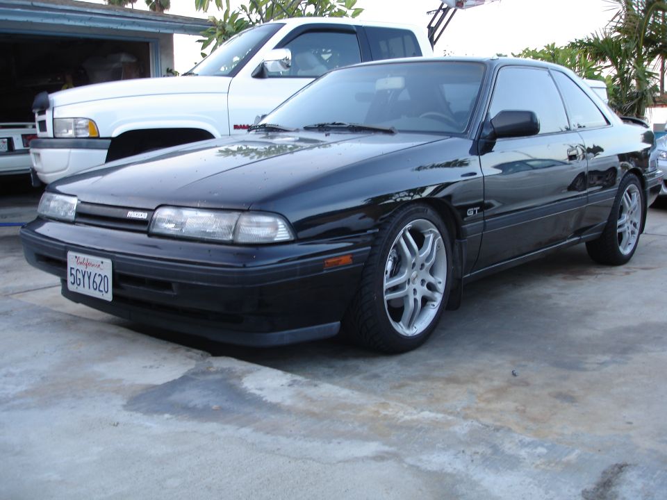 Black Mazda MX-6 GT coupe, front three-quarter, California plate 5GYY620