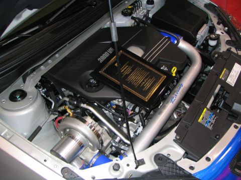 1986 Pontiac Fiero - Close-up view of a modified engine bay, highlighting a turbocharger and custom components.