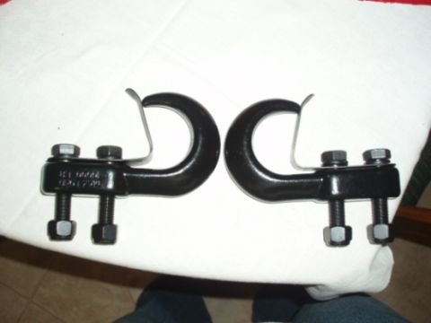 1985 Ford Bronco II - Two black tow hooks are shown, each with two bolts and nuts for attachment.