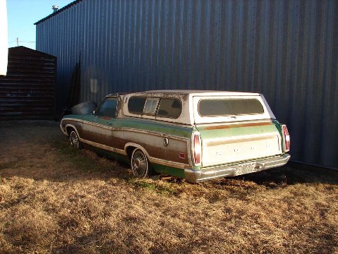 1972 Ford Ranchero - This 1972 Ford Ranchero is seen from the rear, parked next to a corrugated metal building.