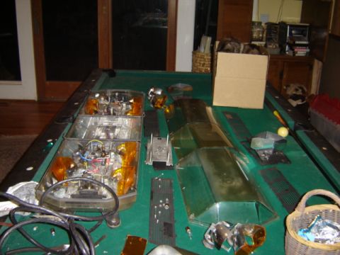 1992 Ford Bronco - Car parts are laid out on a pool table, suggesting a repair or restoration project.