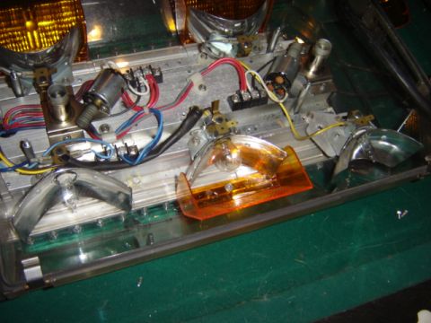 1992 Ford Bronco - Close-up of a vehicle's headlight assembly, showing wiring and an orange turn signal lens.