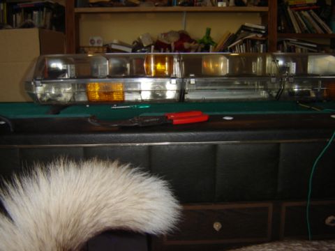 1992 Ford Bronco - A light bar with amber and clear lenses sits on a surface, with tools nearby.