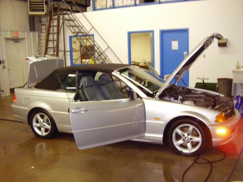 1997 Ford Taurus - Silver convertible with doors and hood open, parked indoors with a metal staircase in the background.