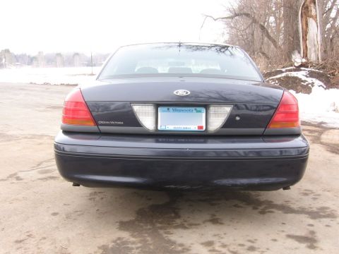 1999 Ford Crown Victoria - Rear view of a dark blue Ford Crown Victoria parked outdoors in winter.