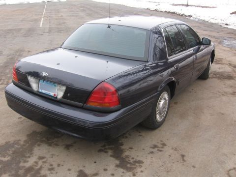 1999 Ford Crown Victoria - Rear view of a dark blue 1999 Ford Crown Victoria parked on pavement.