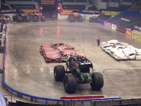 1995 Nissan Frontier - Monster truck event with crushed cars as obstacles.