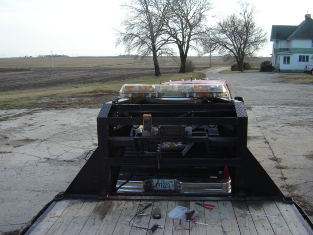 Tow truck bed with wiring, tools, and emergency lights