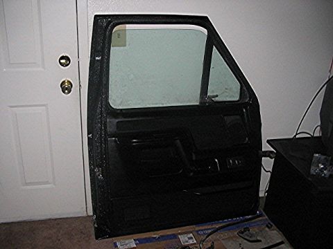 1991 Ford Bronco - A black car door with a window is shown leaning against a wall.