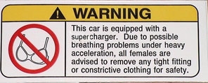 1979 Ford Bronco - A warning sticker advises females to remove constrictive clothing due to breathing issues under heavy acceleration from a supercharger.