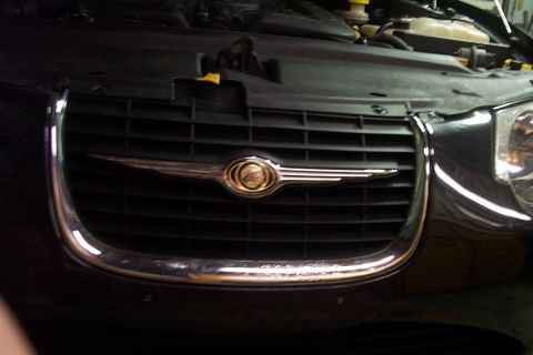 1999 Chrysler 300M - Front view of a 1999 Chrysler 300M showing the grille and emblem with the hood open.