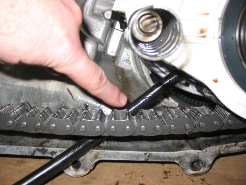 1995 Ford Bronco - Close-up view of a vehicle's timing chain and associated engine parts.
