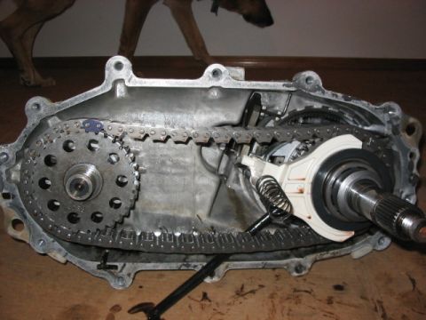 1995 Ford Bronco - Interior view of a disassembled transfer case, showing internal components like chains and gears.