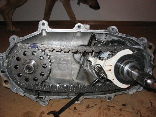 Disassembled transfer case showing chain, sprockets and output shaft