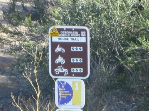 1990 Ford Bronco - Brown forest service sign marking a Designated Vehicle Route called House Trail, with motorcycle, ATV and 4x4 difficulty icons.