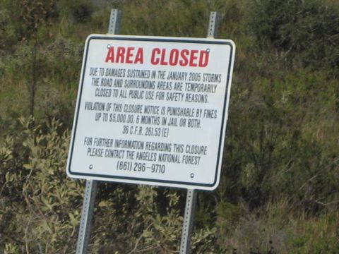 1990 Ford Bronco - photo of a land-closure notice sign, not a vehicle technical document.