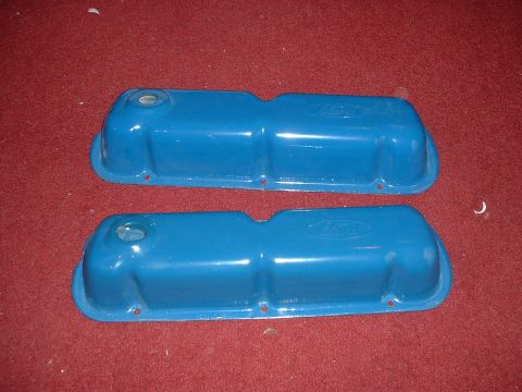 1985 Ford Bronco - Two blue Ford valve covers are shown against a red carpet background.
