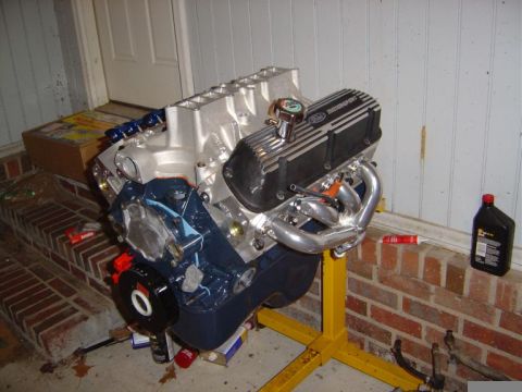 1986 Ford Bronco - A Ford V8 engine, likely a 302 or 351 Windsor, is mounted on an engine stand.