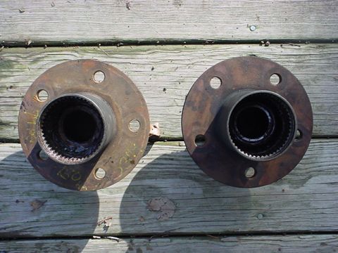 1983 Ford Bronco - Two rusty wheel hubs are shown resting on a wooden surface. The registry claims they are from a 1983 Ford Bronco, but this is unconfirmed.