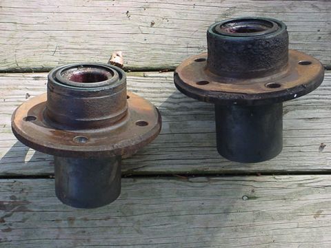 1983 Ford Bronco - Pair of used wheel hubs shown on a wooden deck.